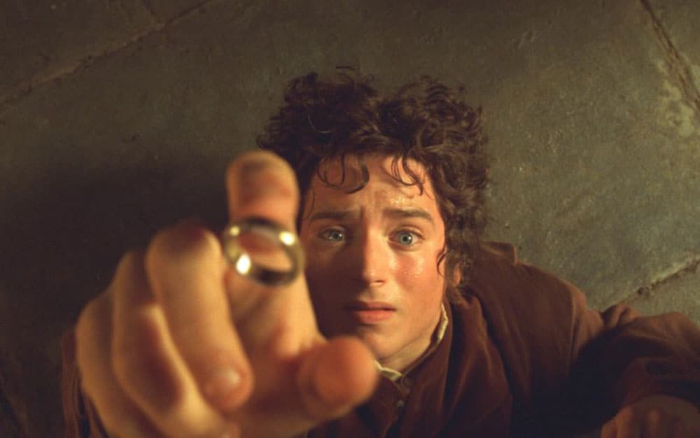 Frodo puts on the Ring.
